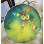 A large wall plate decorated with flowers.