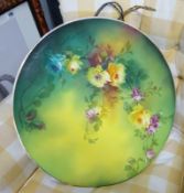 A large wall plate decorated with flowers.