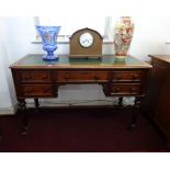 A Victorian mahogany desk on fluted legs, width 122cm.