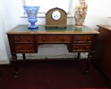 A Victorian mahogany desk on fluted legs, width 122cm.