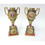 A pair of 20th century Ackeman & Fritze porcelain urns on pedestal bases, height 30cm