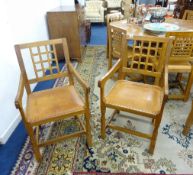 A pair of carved oak 'Mouseman' style lattice back elbow chairs, by Knight Furniture of Yorkshire (