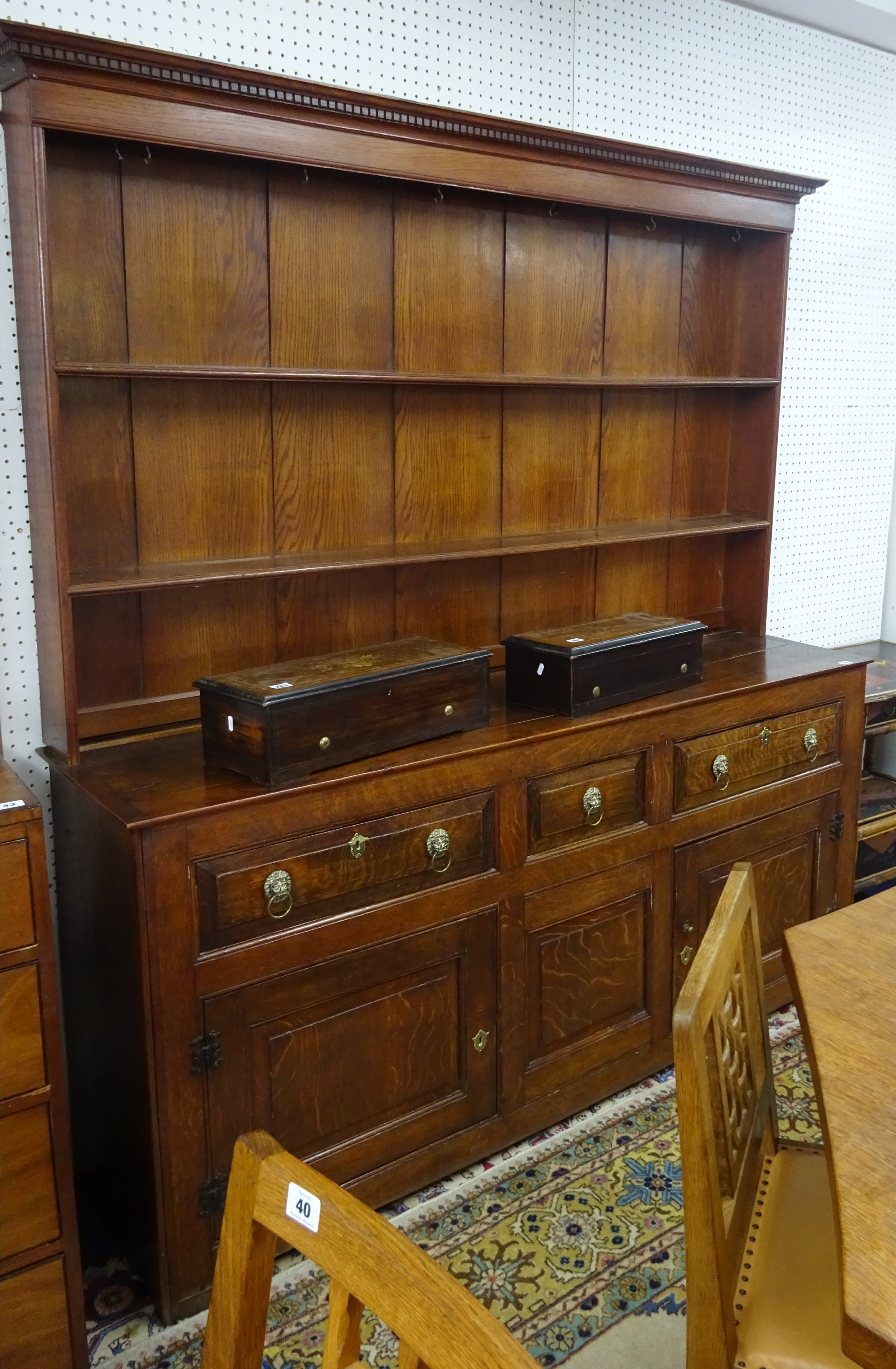 A Georgian oak farmhouse dresser, two parts, the upper section with two shelves and wide back walls,