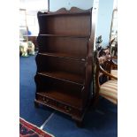 A reproduction mahogany 'waterfall' bookcase fitted with two drawers, width 77cm height 150cm.