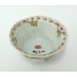 A Chinese porcelain tea bowl decorated inside and out with stylised tree and birds, unusual