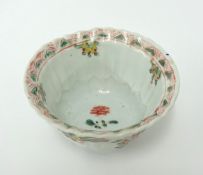 A Chinese porcelain tea bowl decorated inside and out with stylised tree and birds, unusual