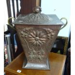 An Art Nouveau style copper and brass coal scuttle with embossed decoration, height 40cm.