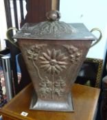 An Art Nouveau style copper and brass coal scuttle with embossed decoration, height 40cm.