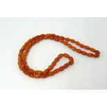 A small amber bead necklace, length approx. 54cm.