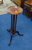 A reproduction mahogany tripod candle stand, height 66cm.