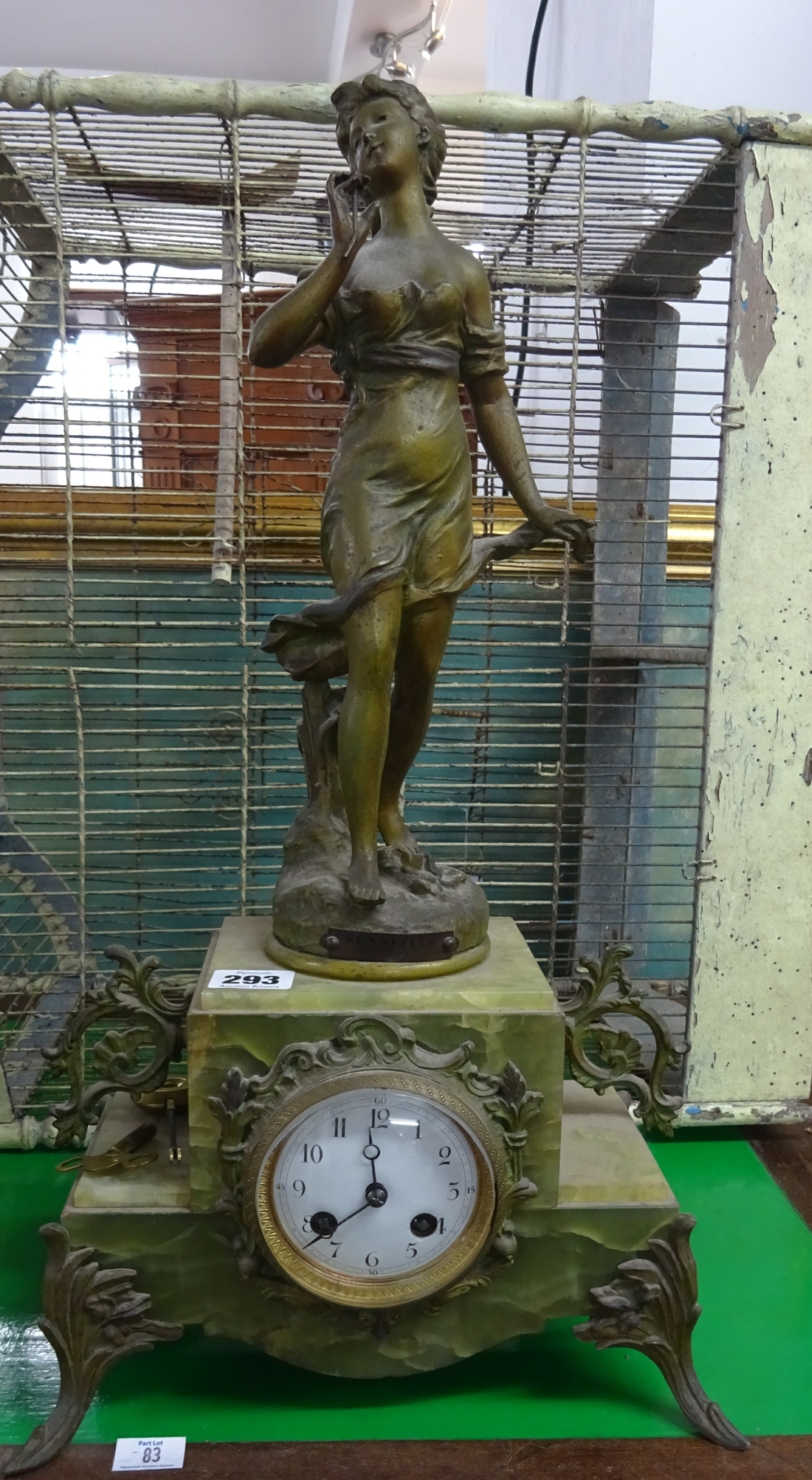 Late Victorian green marble (onyx) and metal figurative clock, height 52cm, with pendulum and key.