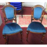 A pair of Victorian mahogany and burr walnut inlaid parlour chairs.