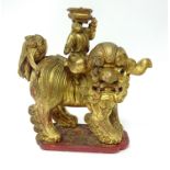 A 20th century Chinese carved wood and gilt dog, height 34cm.