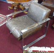 A contemporary leather upholstered and steel/chrome framed armchair.