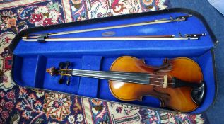 A viola, cased with two bows.