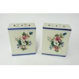 A pair of Chinese 'flower bricks' each decorated with panels of summer flowers, height 18cm.