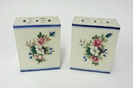 A pair of Chinese 'flower bricks' each decorated with panels of summer flowers, height 18cm.