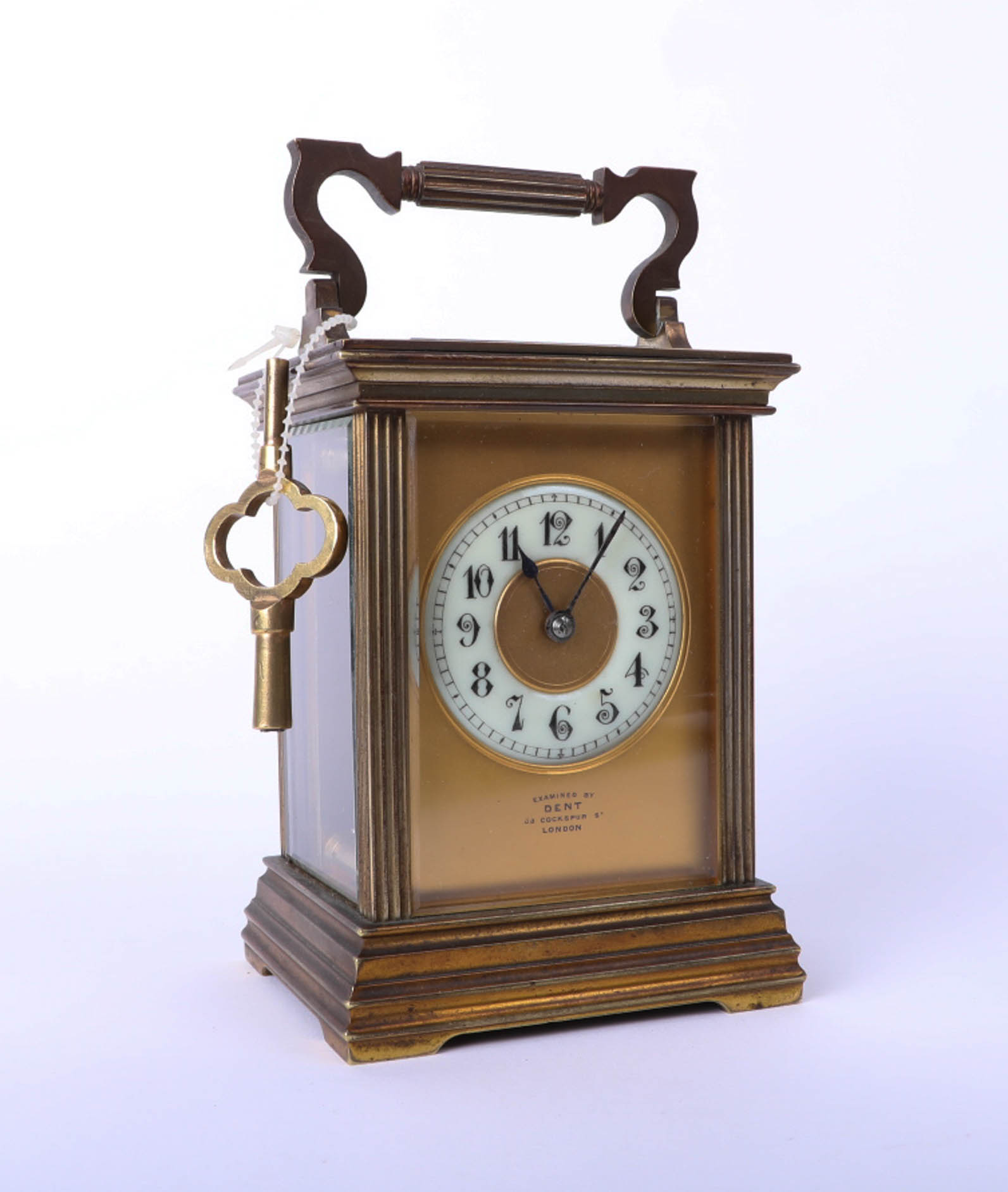 A brass carriage clock, Dent of London, with key, height 13cm.