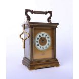 A brass carriage clock, Dent of London, with key, height 13cm.