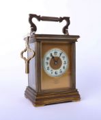 A brass carriage clock, Dent of London, with key, height 13cm.