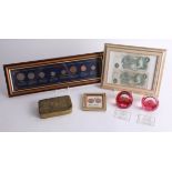 A Great War 'Mary' tin, a Caithness paperweight, two Bank of England £1 Notes, a sterling coin