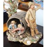 A large Capodimonte porcelain group, boys inside a barrel and man standing at the side, signed LA