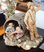 A large Capodimonte porcelain group, boys inside a barrel and man standing at the side, signed LA