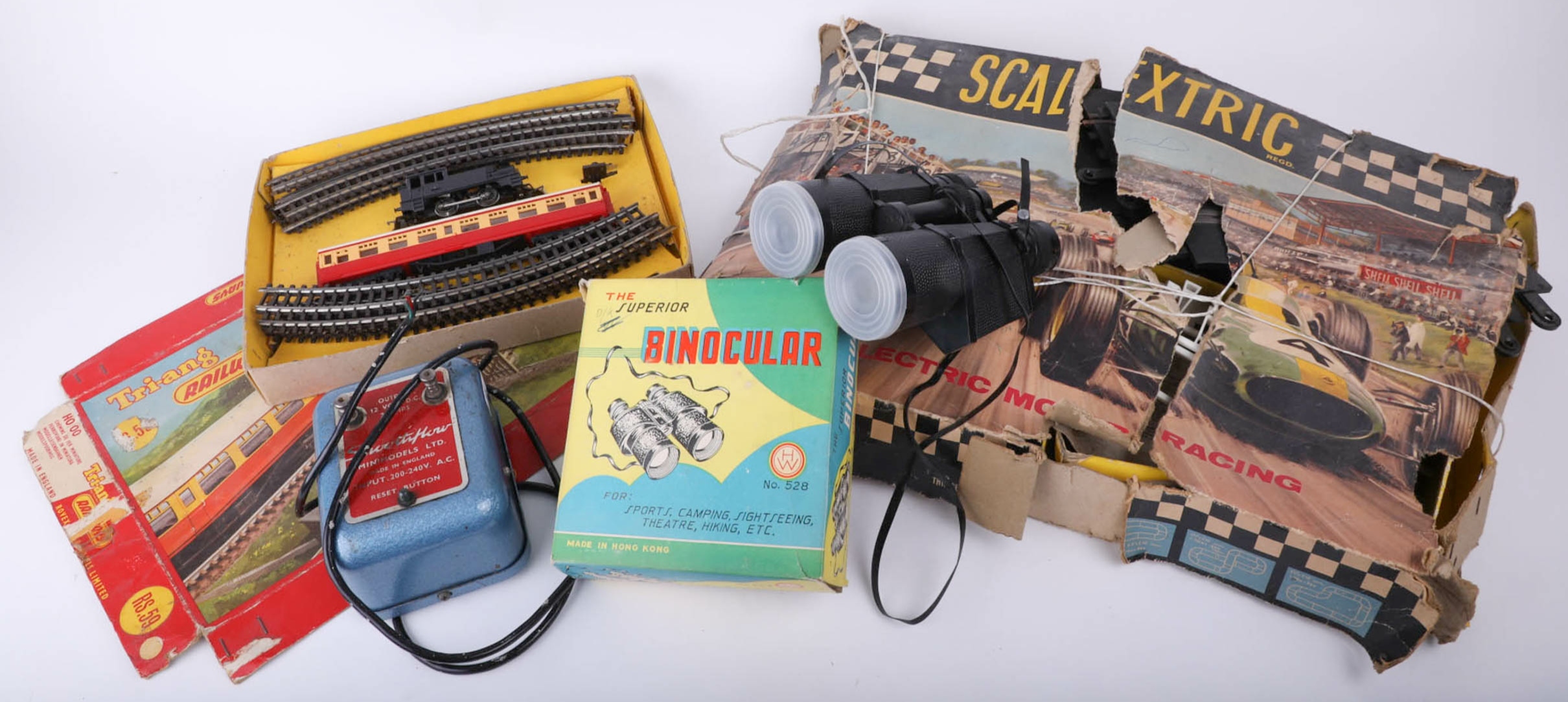 Scalextric motor racing set, boxed binoculars, Triang HO model train set.