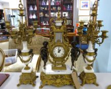 A large continental gilt and marble style three piece clock garniture set decorated with cherubs,