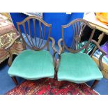 Two mahogany framed elbow chairs.