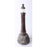 A serpentine lighthouse on a rock base, height 56cm.