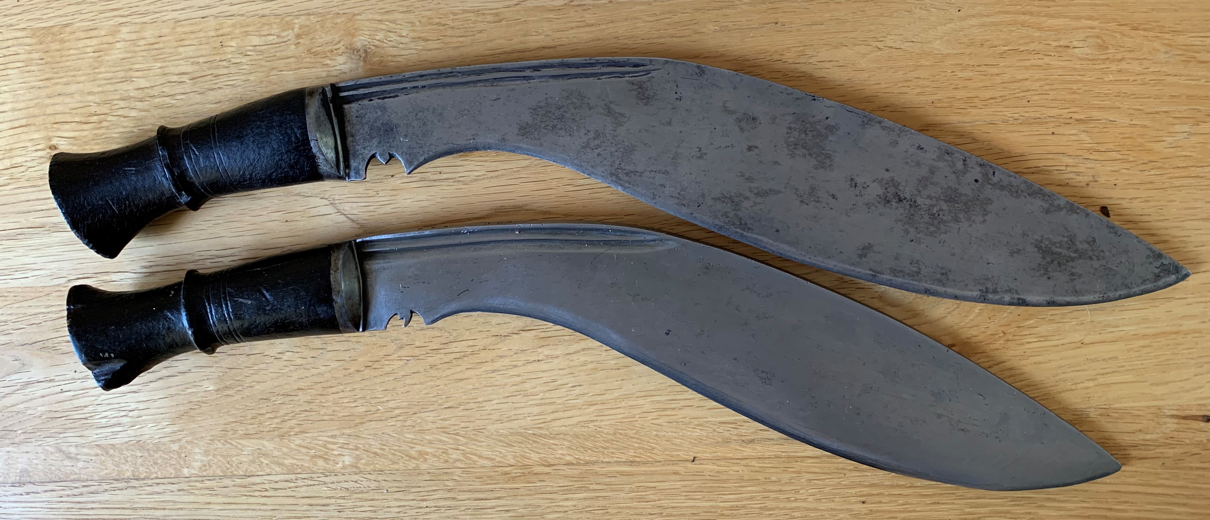 Two very early 20th Century Nepal Army Issue kukri, The larger one; has a blade length of 37cm, with