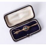 A 15ct brooch set with a coloured stone and pearls, approx 3.6g