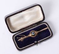 A 15ct brooch set with a coloured stone and pearls, approx 3.6g