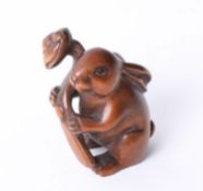 A carved wood netsuke in a form of a hair, height 40mm