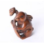 A carved wood netsuke in a form of a hair, height 40mm