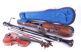 Two cased violins, a bass recorder and an antique acoustic guitar case.