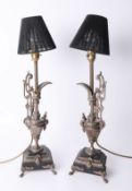 A pair of metal lamps as ewers on stepped bases, 45cm.