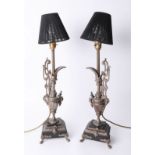 A pair of metal lamps as ewers on stepped bases, 45cm.