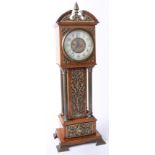 A miniature eight day long case clock with applied ornate pierced brass decoration and four