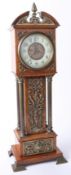 A miniature eight day long case clock with applied ornate pierced brass decoration and four