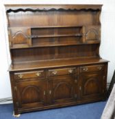 A reproduction oak dresser in two parts length 183cm.