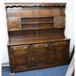 A reproduction oak dresser in two parts length 183cm.