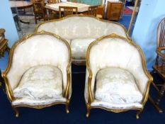 A 19th century Italian style gilt wood framed saloon suite, comprising settee and two armchairs, (ex