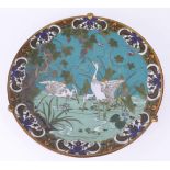 A Japanese cloisonné plate, blue ground with herons, stem base, approx 30cm diameter.