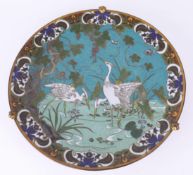 A Japanese cloisonné plate, blue ground with herons, stem base, approx 30cm diameter.