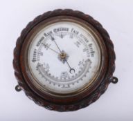 A traditional circular wall barometer.