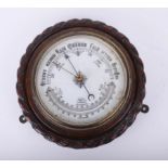 A traditional circular wall barometer.