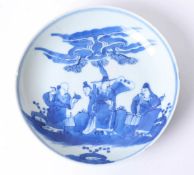 A Chinese porcelain blue and white saucer dish with four underglaze figures marks to the base,