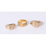 An 18ct wedding band approx 4.5g and two 9ct signet rings approx 8.6g (3)